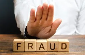 A man rejects the word 'fraud' with his hand