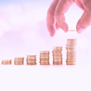 A person creates stacks of money, signifying cash recovery and accounts payable recovery audits.
