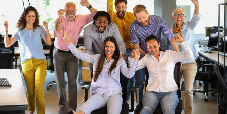 A group of people in an office celebrate