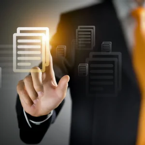 A man taps a virtual screen with two matching documents on it, signifying a duplicate invoice or duplicate payment being found