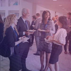 A group of professionals talk at a conference., to signify networking at the APA conference