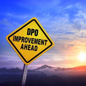 A sunset with a sign in front of it reading 'DPO improvement ahead', signifying improving days payable outstanding in AP