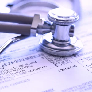 A stethoscope sits atop a budget sheet